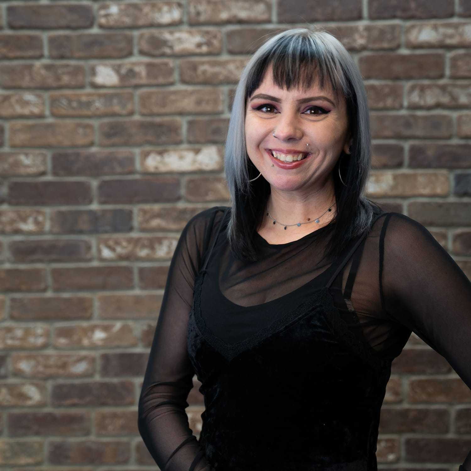 Portrait of Kim, a professional stylist at One83 Mane Studio, showcasing their expertise and style.