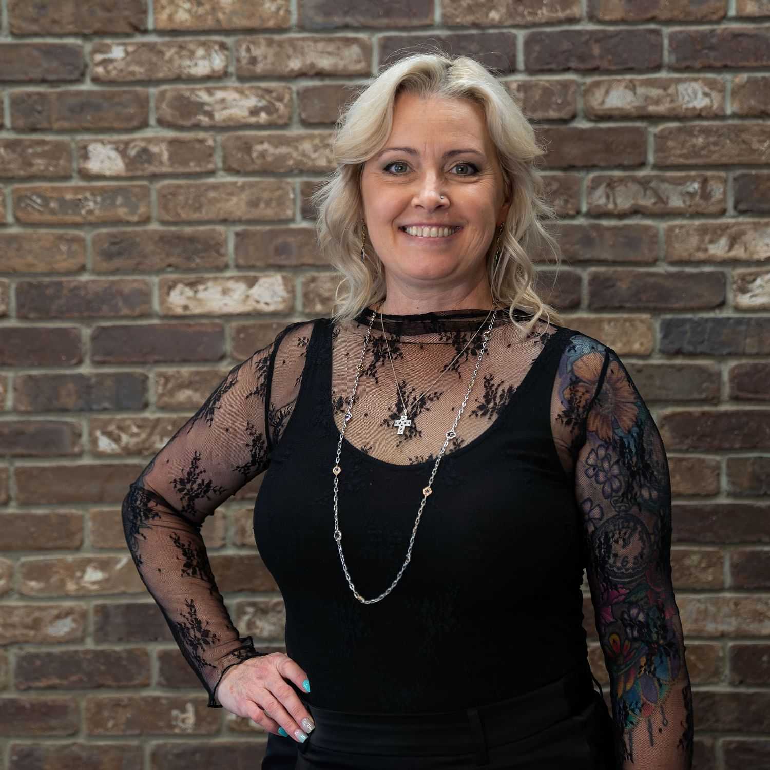 Portrait of Nicole, a professional stylist at One83 Mane Studio, showcasing their expertise and style.