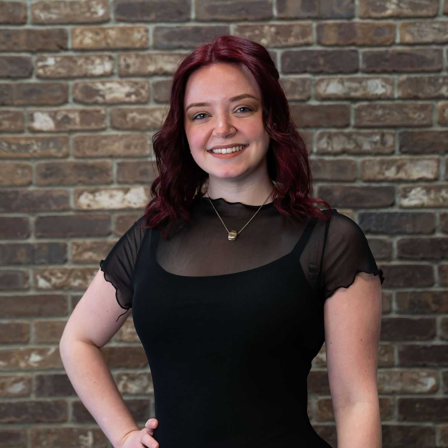 Portrait of Grace, a professional stylist at One83 Mane Studio, showcasing their expertise and style.